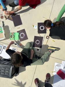 Kids creating art of the total solar eclipse.